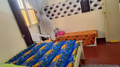 a bedroom with a bed with a colorful sheets at Casa de Férias in Tarrafal