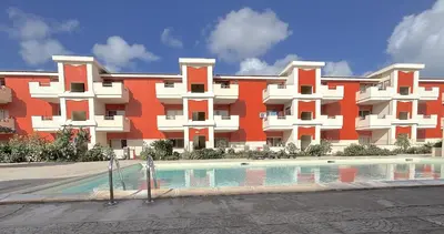 a large building with a swimming pool in front of it at Zen House Morabeza in Santa Maria