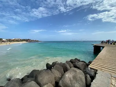 a view of a beach with rocks and a pier at Zen House Morabeza in Santa Maria
