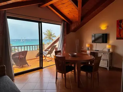 a dining room with a table and a view of the ocean at Porto Antigo 2 - By Bobbywashere in Santa Maria