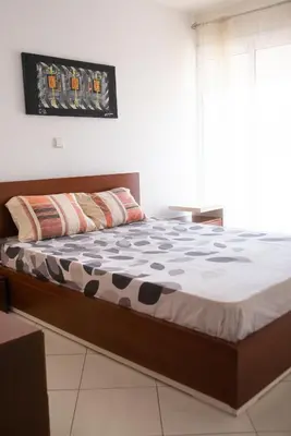 a bedroom with a bed in a room at 2 bdr cozy beachside apartment, Copacabana - LCGR in Mindelo