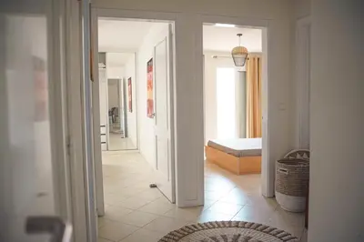 a hallway with a door leading to a bedroom at 2 bdr cozy beachside apartment, Copacabana - LCGR in Mindelo