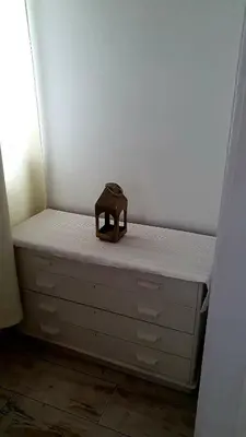 a small stool sitting on top of a dresser at As Hortênsias in Mindelo