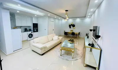 a living room with a couch and a table at Résidence Cazino Apartamentos in Praia