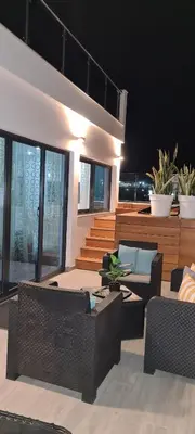a living room with couches and chairs in a house at Résidence Cazino Apartamentos in Praia