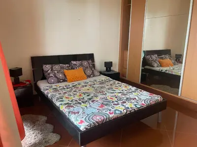 a bed in a room with a mirror at Tarrafal House in Tarrafal