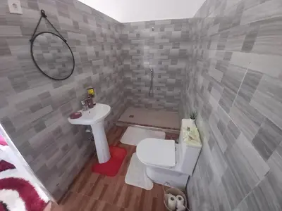 a small bathroom with a sink and a toilet at Tarrafal House in Tarrafal