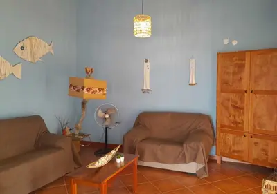 a living room with a couch and a chair at Villa Lagosta Stella Maris Exclusive in Vila do Maio