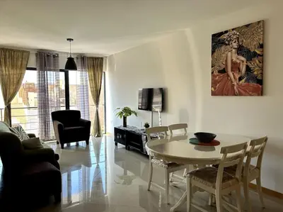 a white living room with a table and chairs at Casa So Morabeza in Mindelo