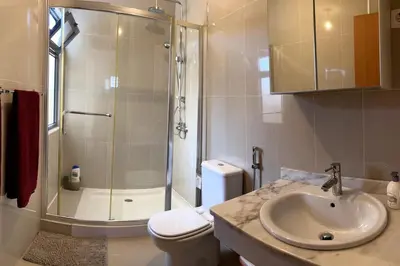 a bathroom with a shower and a sink and a toilet at Casa So Morabeza in Mindelo