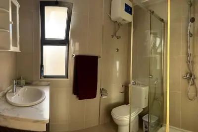 a bathroom with a toilet and a sink and a shower at Casa So Morabeza in Mindelo