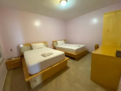 a room with two beds in a room at Spencer Residencial APARTAMENTOS in Praia