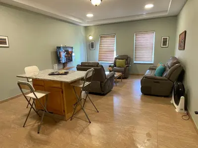 a living room with couches and a table and chairs at Spencer Residencial APARTAMENTOS in Praia