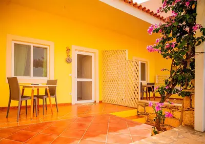 a yellow room with a table and chairs at Appartamento Buzio. Stella Maris Exclusive in Vila do Maio