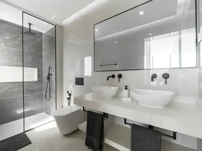 a white bathroom with two sinks and a shower at Apartment Sunset in Mindelo