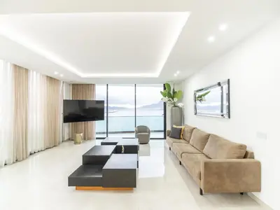a living room with a couch and a tv at Apartment Sunset in Mindelo