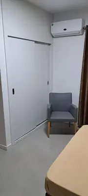 a room with a blue chair and a white wall at Apartamentos Santiago - Tarrafal in Tarrafal