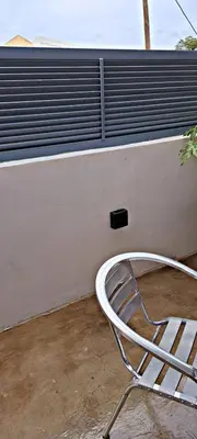 a white chair sitting in front of a wall at Apartamentos Santiago - Tarrafal in Tarrafal