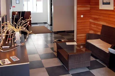a lobby with a couch and a table in a room at Kolina D´Sol in Ponta do Sol